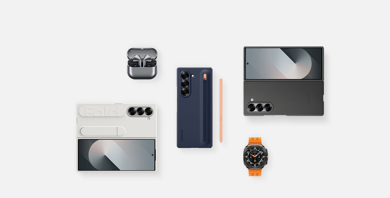 Uma disposição plana de acessórios para o Galaxy Z Fold6: Galaxy Buds3 Pro em Grafite com a Capa dos buds aberta e os buds colocados no interior, Galaxy Z Fold6 com a Capa da S-pen em Azul Escuro com a S-pen Rosa ao lado, Galaxy Z Fold6 com a Capa Vegana em Cinzento, Galaxy Watch Ultra em Cinzento Escuro e Galaxy Z Fold6 com a Capa Standing com Fita em Branco.